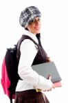 Female Student In Cap With Her School Bag And Study Material Stock Photo