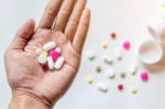 Top View Of The Pills On The Hand And White Background, A Hand Hold The Pills And Drug Stock Photo