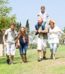 Happy Family Running Towards Camera Stock Photo