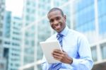 Middle Aged Businessman Using A Tablet Stock Photo