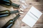 Red Wine Bottle, Glass And Grape Shaped Corks And Open Book Stock Photo