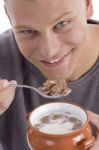 Smiling Man Eating Cornflakes Stock Photo