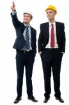 Two Men In Hard Hats Looking Away Stock Photo