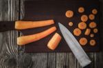 Cutting Carrots On The Wooden Board Top View Stock Photo