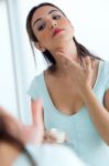 Young Woman Caring Of Her Skin Standing Near Mirror In The Bathr Stock Photo