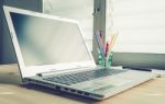 Laptop And Notebook And Pen On Wood Table On Blue Vintage Style Stock Photo