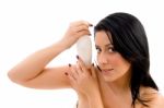 Portrait Of Female Holding Lotion Bottle Against White Background Stock Photo