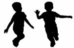 Silhouettes Of Two Little Boys Stock Photo