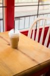 Iced Coffee Serving On Wooden Table Stock Photo