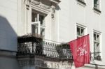 Red Flag Flying From A Building In Krakow Stock Photo