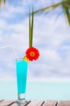 Blue Lagoon Cocktail On The Table At Tropical Beach Stock Photo