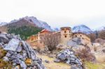 Tibetan Temple On The Snow Mountain  With Gray Rocks Stock Photo