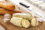 Baguette With Herb Butter And Rosemary Thyme On Rustic Wooden Background Stock Photo