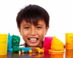 Boy Playing With Colored Dough Stock Photo