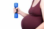 Pregnant Woman Exercising With Dumbbell Stock Photo