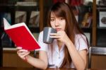 Portrait Of Thai Adult Student University Uniform Beautiful Drinking Coffee Stock Photo