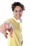 Guy With Headphones Pointing Stock Photo