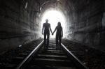 Couple Walking Together Through A Railway Tunnel Stock Photo