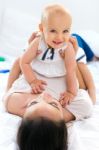 Baby Girl And Her Mother Playing At Home Stock Photo