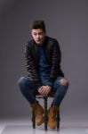 Casual Young Man In Black Leather Jacket And Denim Jeans Stock Photo