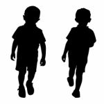 Silhouettes Of Two Little Boys Stock Photo