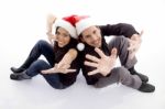 Young Couple Wearing Christmas Hat With Hand Gesture Stock Photo