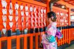 Asian Women Wearing Japanese Traditional Kimono Visiting The Beautiful In Fushimi Inari Shrine In Kyoto, Japan Stock Photo