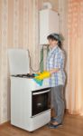 Young Woman Washes A Gas Stove Stock Photo