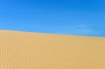 Sand Dune And Blue Sky Stock Photo