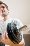 Man Lifting Dumbbell In Gym Stock Photo