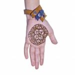 Mehendi Or Henna Tatoo On The Female Hands In Bracelets Isolated Stock Photo