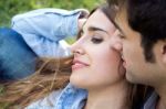 Outdoor Portrait Of Young Caucasian Couple At The Park Stock Photo