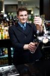 Bartender holding glass Stock Photo