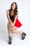 Fashionable Brunette Woman With Long Slim Legs Posing In Studio Stock Photo