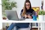 Confident Young Woman Working In Her Office With Mobile Phone Stock Photo