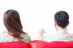 Rear View Of Young Couple Watching Tv On Sofa Stock Photo