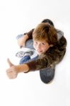 Top View Of Boy Sitting On Skateboard Stock Photo