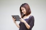 Portrait Of Thai Adult Student University Beautiful Girl Using Her Tablet Stock Photo