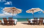 Table Set And Umbrella On The Beach Stock Photo