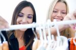 Two Young Friends Looking For Clothes In The Store Stock Photo