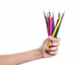 Colored Pencils In A Female Hand On A White Background  Stock Photo