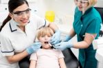 Female Dentist Examine Child Patient Stock Photo