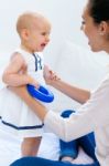 Baby Girl And Her Mother Playing At Home Stock Photo