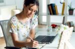 Pretty Young Woman Using Her Laptop In The Office Stock Photo