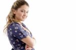 Side View Of Smiling Young Girl With Crossed Arms Stock Photo