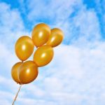 Golden Flying Balloons On The Sky Background Stock Photo