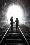 Couple Walking Together Through A Railway Tunnel Stock Photo