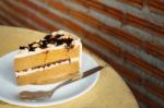 Slice Of Coffee Cake On Dish On The Wooden Table Stock Photo