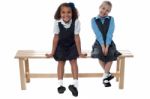 Little Girls Sitting On The Bench Stock Photo