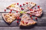 Pizza Cuts And Cherry Tomatos On Wooden Table Stock Photo